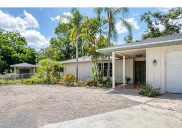 Charming single-story home with mature landscaping and a welcoming entrance, located in a desirable neighborhood at 2866 E Rainbow Cir, Sarasota, FL 34231