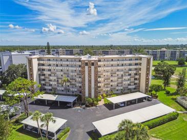 Exterior shot of building with balconies and covered parking on a sunny day at 3680 Ironwood Circle # 704-L, Bradenton, FL 34209