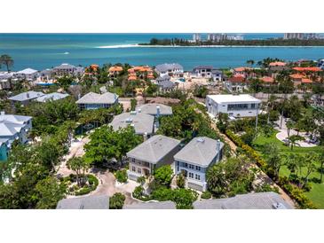 Stunning aerial view showcasing luxurious beachfront homes and the sparkling ocean coastline at 3959 Somerset Dr # 5, Sarasota, FL 34242