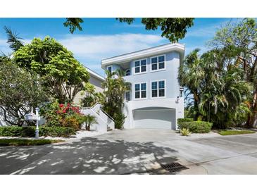 Beautiful two-story waterfront home with a driveway and lush landscaping at 3959 Somerset Dr, Sarasota, FL 34242