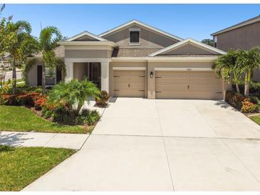 Charming single-Gathering home with a two-car garage and lush landscaping in a desirable neighborhood at 5802 Alabaster Stone Ln, Apollo Beach, FL 33572