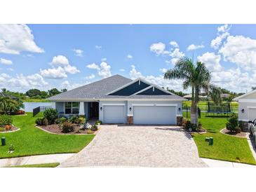 Beautiful single-story home with a two-car garage, paver driveway, and well-manicured landscaping at 5910 Hevena Ct, Palmetto, FL 34221