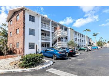 Condo complex featuring white exterior, brick accents and ample parking at 1540 Pleasant Rd # G35, Bradenton, FL 34207