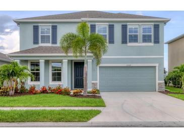Charming two-story home with a well-maintained lawn, beautiful landscaping, and a two-car garage at 12564 Night View Dr, Sarasota, FL 34238