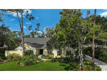 Charming home featuring lush landscaping, a well-manicured lawn, and a welcoming entrance at 140 Sugar Mill Dr, Osprey, FL 34229