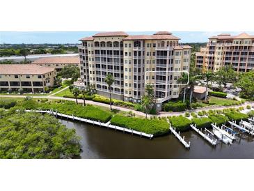 Luxury waterfront condo building with private boat docks and lush landscaping at 1921 Monte Carlo Dr # 302, Sarasota, FL 34231