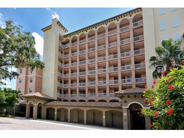 Beautiful multi-story condo building featuring private balconies and covered parking, set in a lush, tropical landscape at 1921 Monte Carlo Dr # 302, Sarasota, FL 34231
