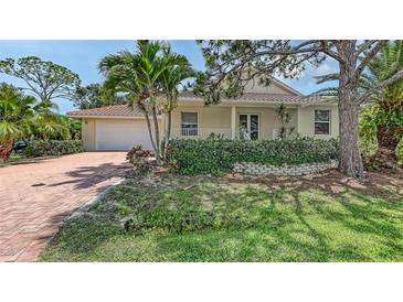 Charming single-Gathering home with a well-manicured lawn and a red brick driveway at 205 Sugarloaf Dr, Nokomis, FL 34275