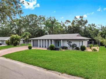 Charming single-story home with a well-manicured lawn and inviting curb appeal at 4455 Emerald Ridge Dr, Sarasota, FL 34233