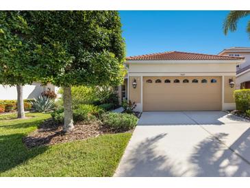 Charming single-Gathering home with a two-car garage, beautiful landscaping, and a terracotta roof at 7419 Birds Eye Ter, Bradenton, FL 34203