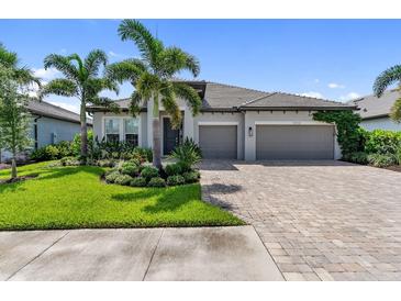 Beautiful single-story home featuring a well manicured lawn, lovely landscaping and two-car garage at 17737 Savory Mist Cir, Bradenton, FL 34211