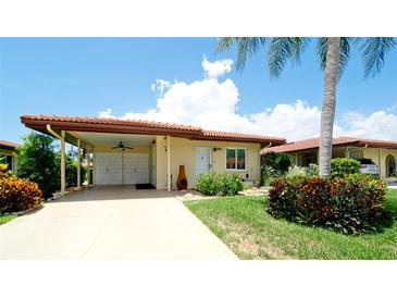 Charming single-story home with a terracotta tile roof, covered carport, and well-manicured landscaping at 3305 Notre Dame Pl # 3305, Bradenton, FL 34207