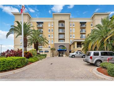 Beautiful building with palm trees and mature landscaping under a bright blue sky on a sunny day at 1064 N Tamiami Trl # 1125, Sarasota, FL 34236