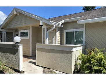 Inviting front entrance with beige siding and brick accents, creating a warm and welcoming atmosphere at 3032 Heron Lake Ct # 7B, Venice, FL 34293