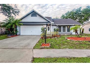 Charming home with a well-maintained lawn, mature trees, and an attached two-car garage at 3404 56Th Dr E, Bradenton, FL 34203