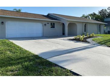 Charming home with a new driveway and updated landscaping with palm trees at 481 Saturn Ave, Sarasota, FL 34243