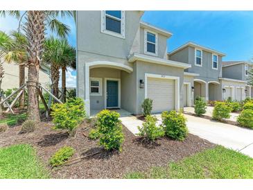 Charming two-story home with a well-manicured lawn, attached garage, and a welcoming front entrance at 5711 Archipelago St, Nokomis, FL 34275