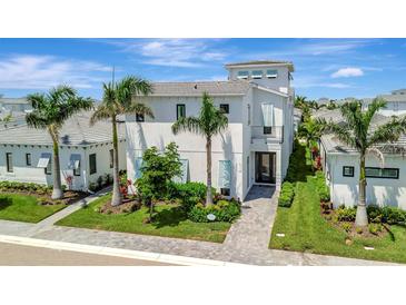 Beautiful two-story home with a manicured lawn and lush tropical landscaping at 6317 Turtle Grass Dr, Bradenton, FL 34210