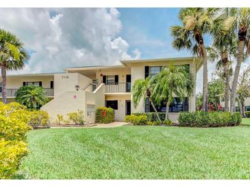 Inviting two-story condo with lush landscaping, mature palms, and manicured lawn at 7110 Fairway Bend Ln # 181, Sarasota, FL 34243