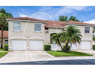 Charming townhome featuring a well-manicured lawn and a classic red tile roof at 7137 Cedar Hollow Cir, Bradenton, FL 34203