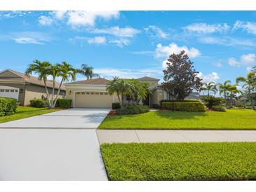 Charming single-story home with a manicured lawn, mature palm trees, and a spacious driveway at 7615 Charleston St, Bradenton, FL 34201