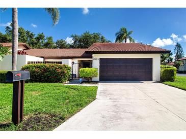 Charming single-story home featuring a well-manicured lawn, tile roof, and attached two-car garage at 3615 Puerta Ct # 8516, Sarasota, FL 34232