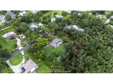 Aerial view showing the home with a large lot surrounded by mature trees in a quiet neighborhood at 5430 Richardson Rd, Sarasota, FL 34232