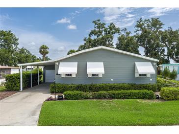Charming single-story home with covered parking, awning-covered windows, and well-maintained landscaping at 6710 36 E Ave # 114, Palmetto, FL 34221