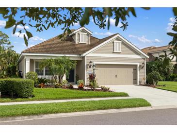 Charming single-story home showcasing a well-maintained lawn, landscaped garden, and a two-car garage at 12261 Stuart Dr, Venice, FL 34293