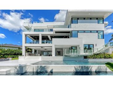 Stunning modern home with a multi-level deck, outdoor kitchen, and beautiful pool overlooking the water at 1610 N Lodge Dr, Sarasota, FL 34239