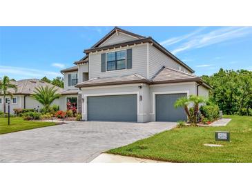 Beautiful two-story home with a three-car garage and professionally landscaped yard at 16231 Tradewind Ter, Bradenton, FL 34211
