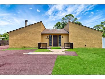 Charming single-story home with modern design and unique landscaping in the front yard at 2315 Riverwood Pines Dr, Sarasota, FL 34231