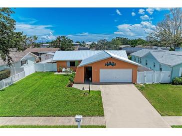 Charming single-Gathering home with a well-maintained lawn, white picket fence, and a one-car garage at 2406 15Th W St, Palmetto, FL 34221