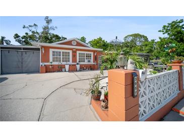 Charming single-story home with a cozy exterior, well-maintained landscaping, and a welcoming front yard at 3957 Proctor Rd, Sarasota, FL 34233