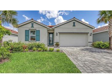 Charming single-story home with well-manicured lawn, tile roof and paver driveway at 491 Daylily Blvd, Nokomis, FL 34275