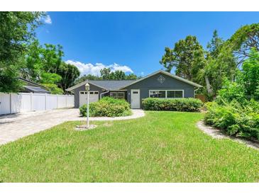Charming single-story home with a well-manicured lawn and lovely front yard landscaping at 5415 13Th Avenue W Dr, Bradenton, FL 34209