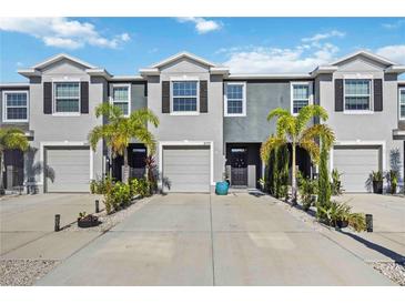 Charming townhomes with well-maintained landscaping, driveways, and two-car garages at 8979 Milestone Dr, Sarasota, FL 34238