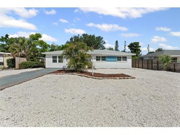 Charming single-story home featuring a well-maintained yard, rock landscaping, and a sunny blue sky at 1404 Dartmouth Dr, Bradenton, FL 34207