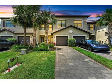 Inviting townhome with a well-manicured lawn and a paved driveway, nestled in a vibrant community with lush landscaping at 15225 Lyla Ter, Bradenton, FL 34211