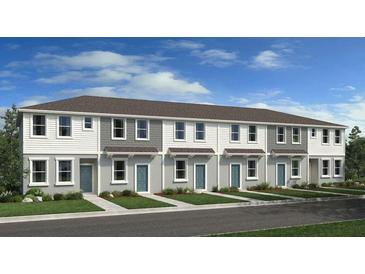 Attractive townhome exterior with neat landscaping, light gray paint, gray shingles and light blue doors at 16538 San Nicola Pl, Bradenton, FL 34211