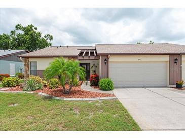 Charming single-story home with a well-manicured lawn and an attached two-car garage at 204 Aspen St, Englewood, FL 34223