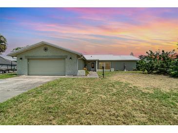 Charming one-story home with a two-car garage and a well-maintained lawn, perfect for suburban living at 2919 Shannon Drive, Punta Gorda, FL 33950