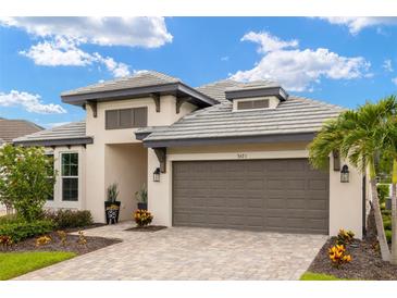 Charming single-Gathering home with a well-manicured lawn, tile roof, and a two-car garage at 3621 Wild Blossom Pl, Parrish, FL 34219