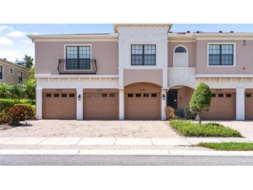 Attractive townhome featuring brick driveway, multiple garage doors, and neutral colored exterior at 4235 Overture Cir # 4235, Bradenton, FL 34209