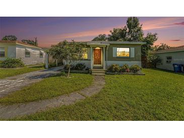 Charming single-story home with well-maintained lawn, mature tree, and inviting front entrance at 5028 Oxford N Ave, St Petersburg, FL 33710