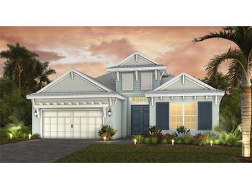Inviting two-story home featuring a two car garage, landscaped yard, and covered front entry at 6224 Isla Del Ray Ave, Sarasota, FL 34240