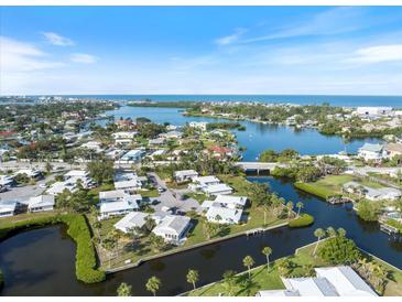 Beautiful aerial view of a waterfront community with canals and access to the ocean on a clear, sunny day at 107 Clipper Way # 107, Nokomis, FL 34275