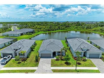An aerial view of the home's tile roof and backyard pond at 11327 Burgundy Dr, Venice, FL 34293