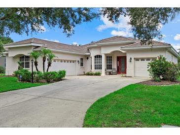 Stunning single Gathering home with a well manicured lawn, three car garage and beautiful curb appeal at 11508 30Th E Cv, Parrish, FL 34219
