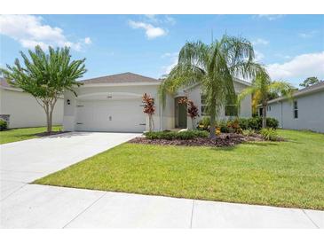 Charming home with a well manicured lawn and colorful landscaping at 13804 Woodbridge Ter, Lakewood Ranch, FL 34211